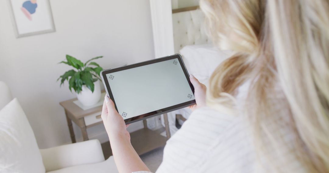 Woman Holding Digital Tablet in Bright Modern Living Room - Free Images, Stock Photos and Pictures on Pikwizard.com