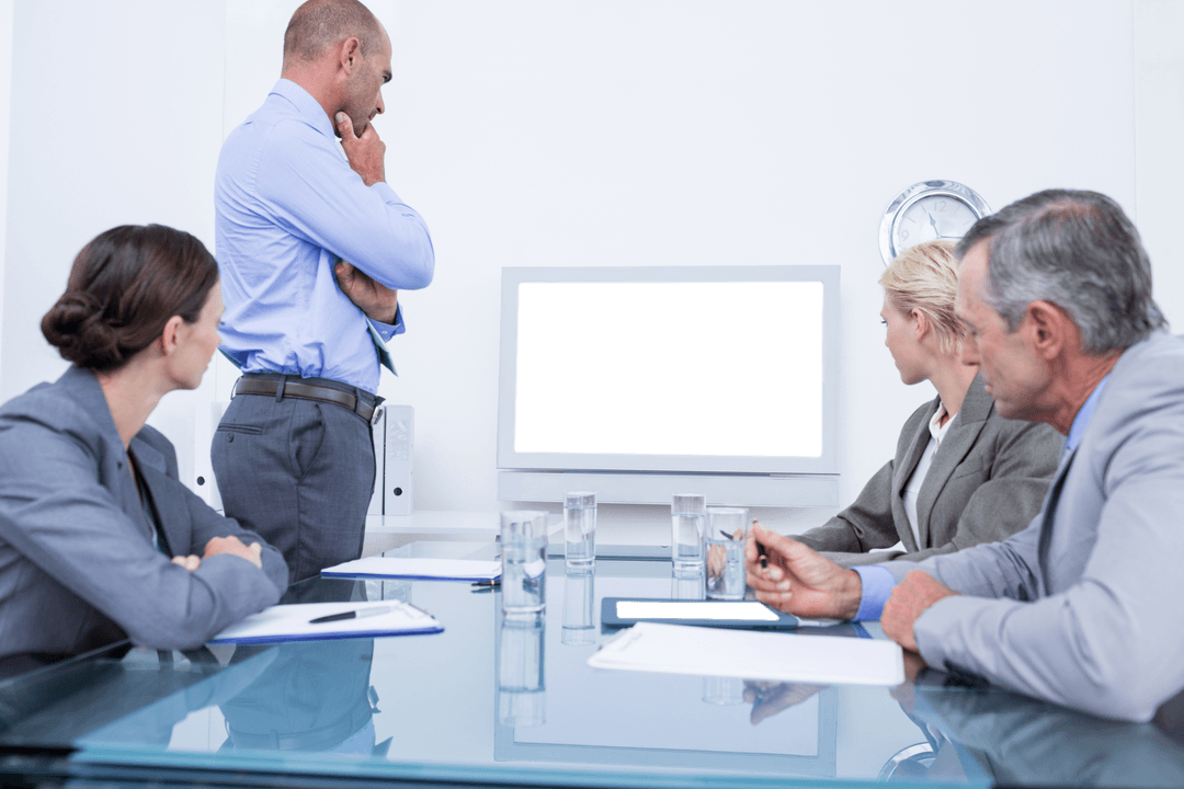 Business Team Analyzing Transparent Glass Screen in Meeting Room