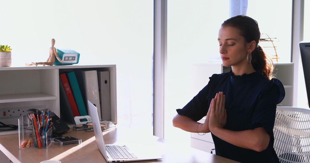 Businesswoman Practicing Meditation at Work in Modern Office - Free Images, Stock Photos and Pictures on Pikwizard.com