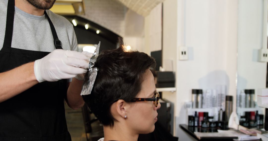 An expert hairstylist meticulously cuts a young Asian woman's hair in a chic salon. - Free Images, Stock Photos and Pictures on Pikwizard.com