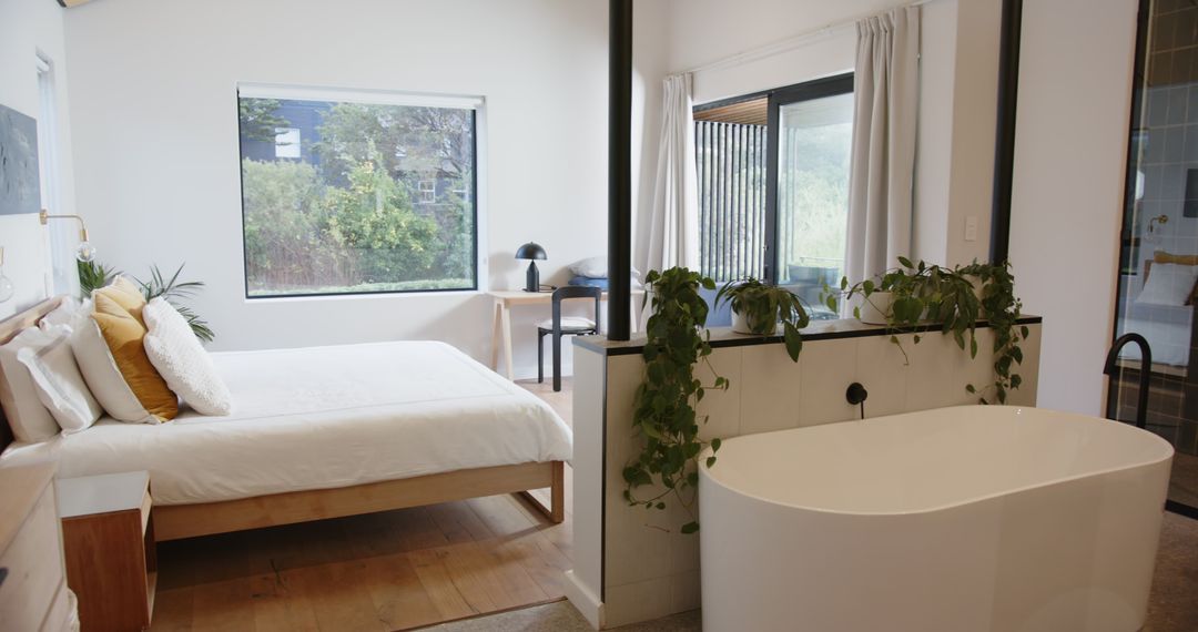 Modern Minimalist Suite with Freestanding Bathtub and Nature View
