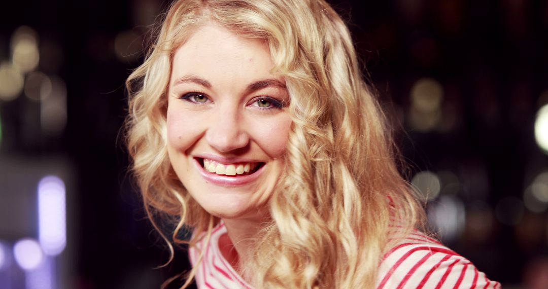 Smiling Young Woman with Blonde Curly Hair in Striped Shirt - Free Images, Stock Photos and Pictures on Pikwizard.com