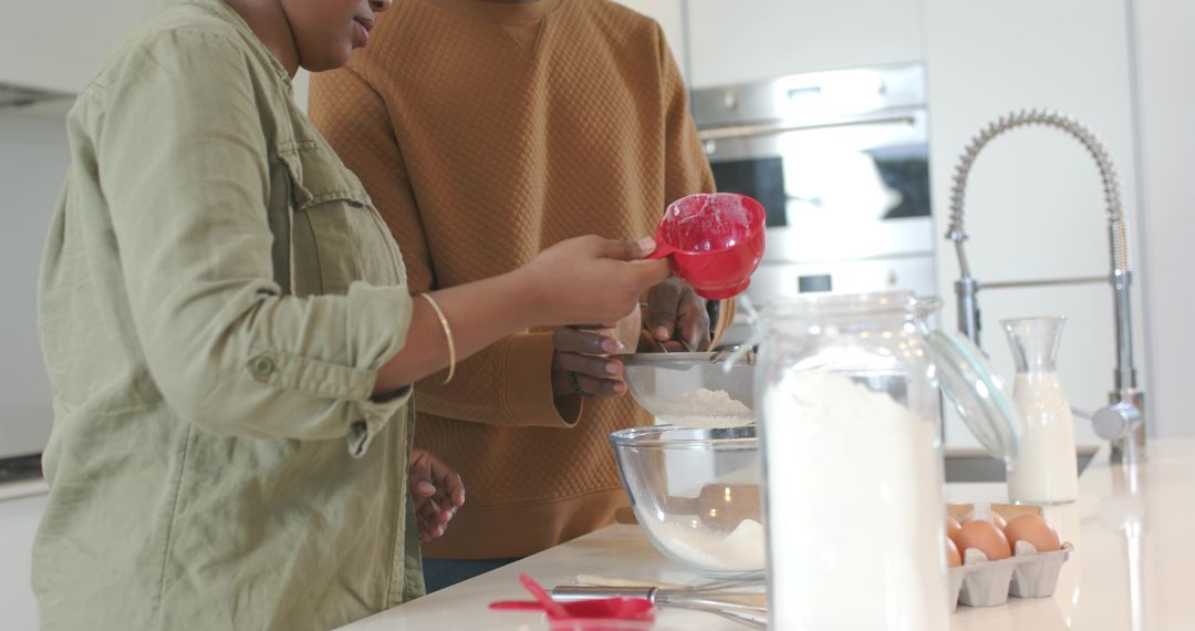 Couple Sifting Flour Together at Modern Kitchen Island for Home Baking and Togetherness