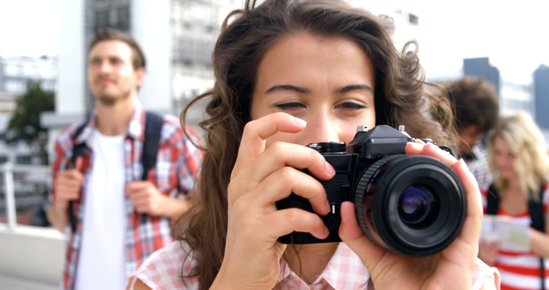 Young Woman Photographing Outdoors in Urban Setting - Free Images, Stock Photos and Pictures on Pikwizard.com