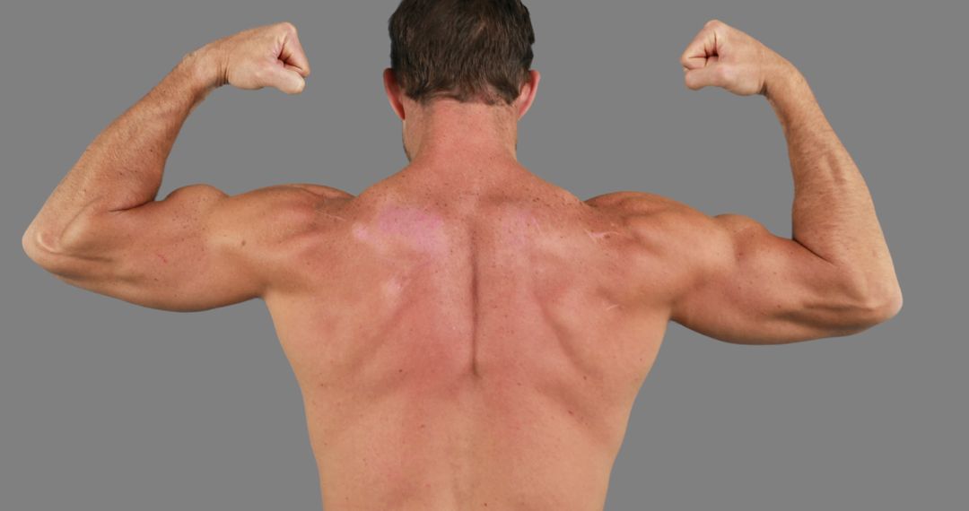 A middle-aged man displays his muscular back and arms, highlighting his fitness commitment. - Free Images, Stock Photos and Pictures on Pikwizard.com