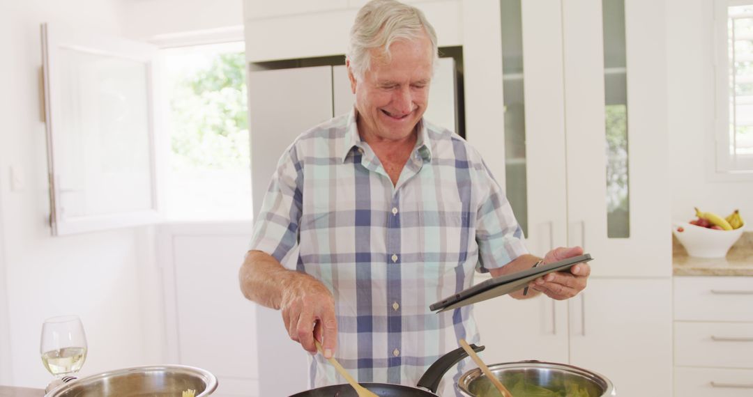 Elderly Man Following Recipe on Tablet While Cooking - Free Images, Stock Photos and Pictures on Pikwizard.com