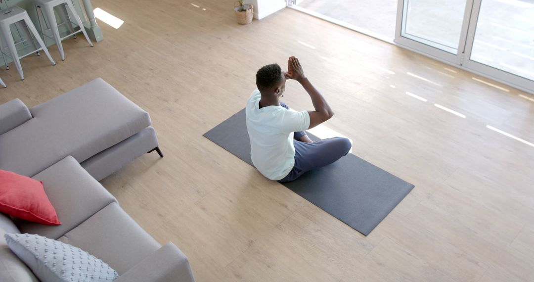 Man Practicing Yoga at Home on Mat by Living Room Window - Free Images, Stock Photos and Pictures on Pikwizard.com