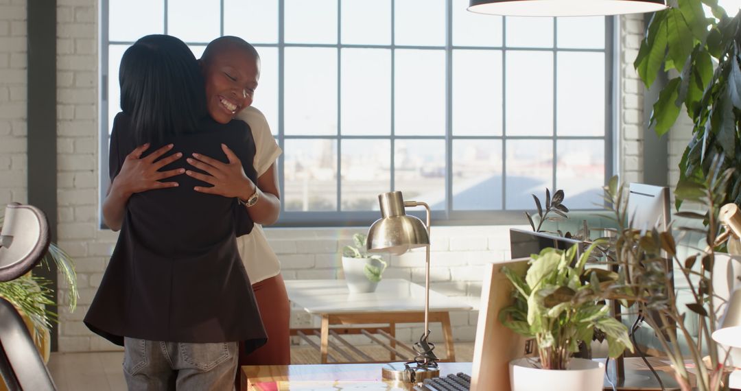 Colleagues Embracing in Bright Modern Office Setting