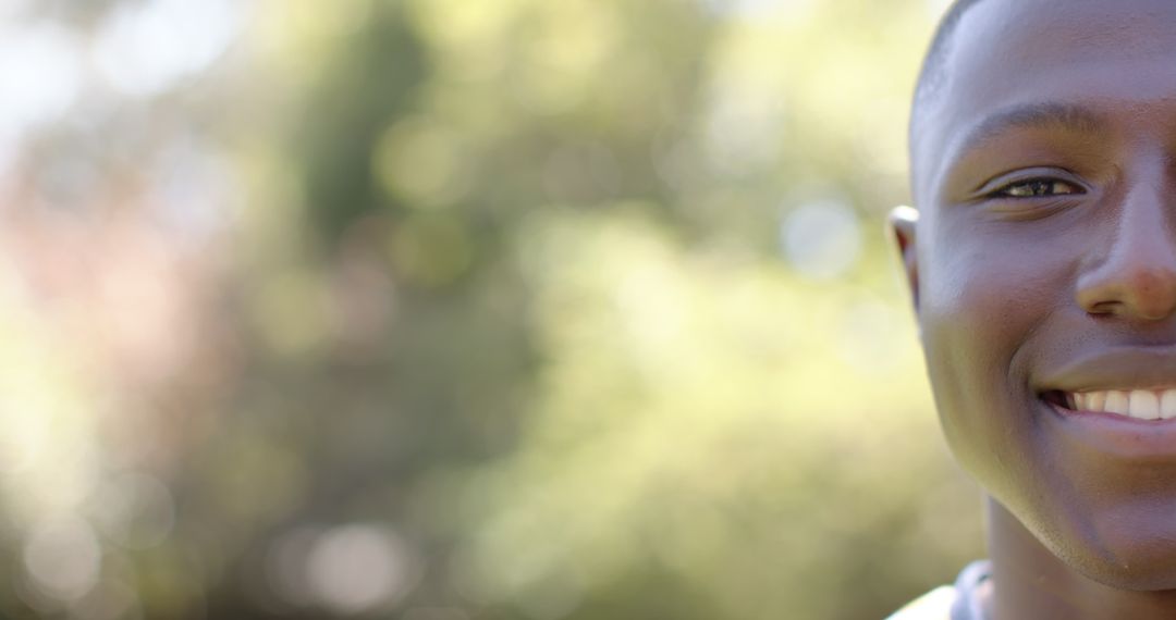 Smiling man enjoying relaxation in nature among green foliage