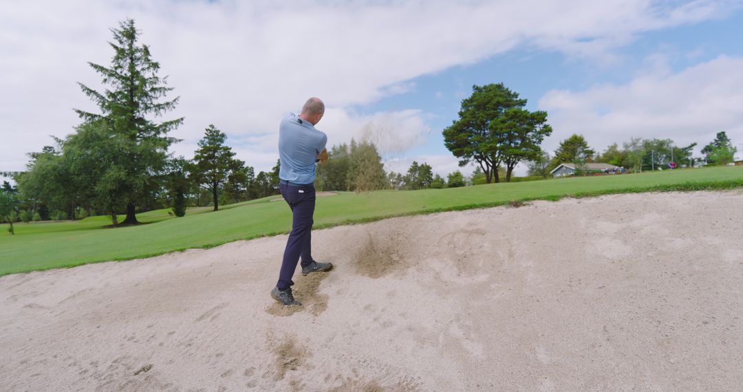 Man Playing Golf Hitting Sand Bunker on Sunny Course