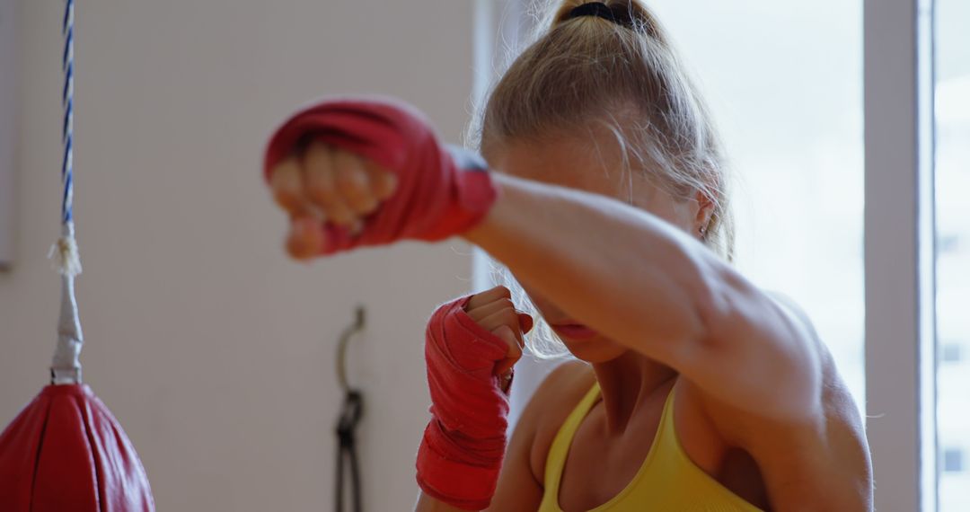 Woman Practicing Boxing with Red Hand Wraps - Free Images, Stock Photos and Pictures on Pikwizard.com