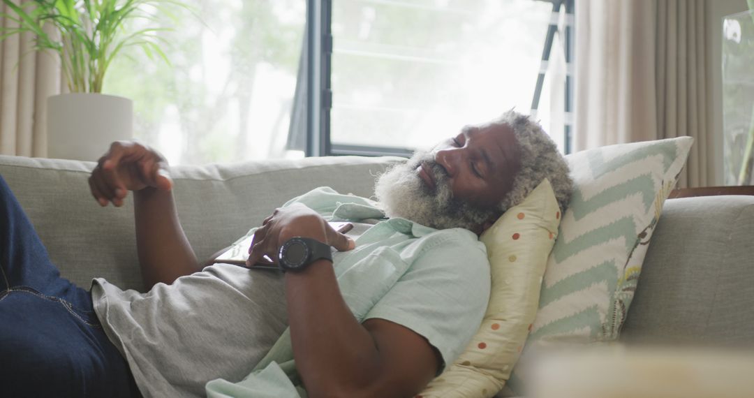 Image of sad african american senior man laying on sofa - Free Images, Stock Photos and Pictures on Pikwizard.com