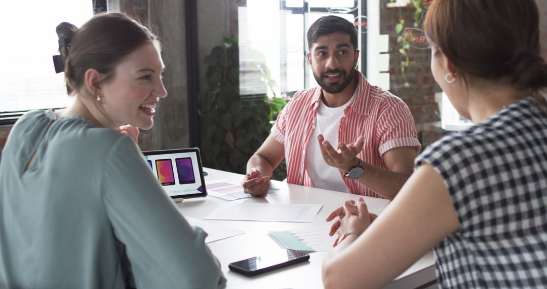 Diverse Team Collaborating on App Design at Modern Office
