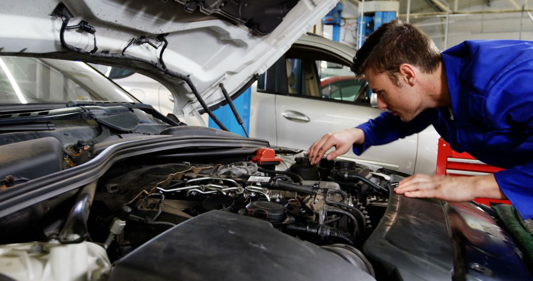 Young Mechanic Diagnosing Car Engine in Auto Repair Shop - Free Images, Stock Photos and Pictures on Pikwizard.com