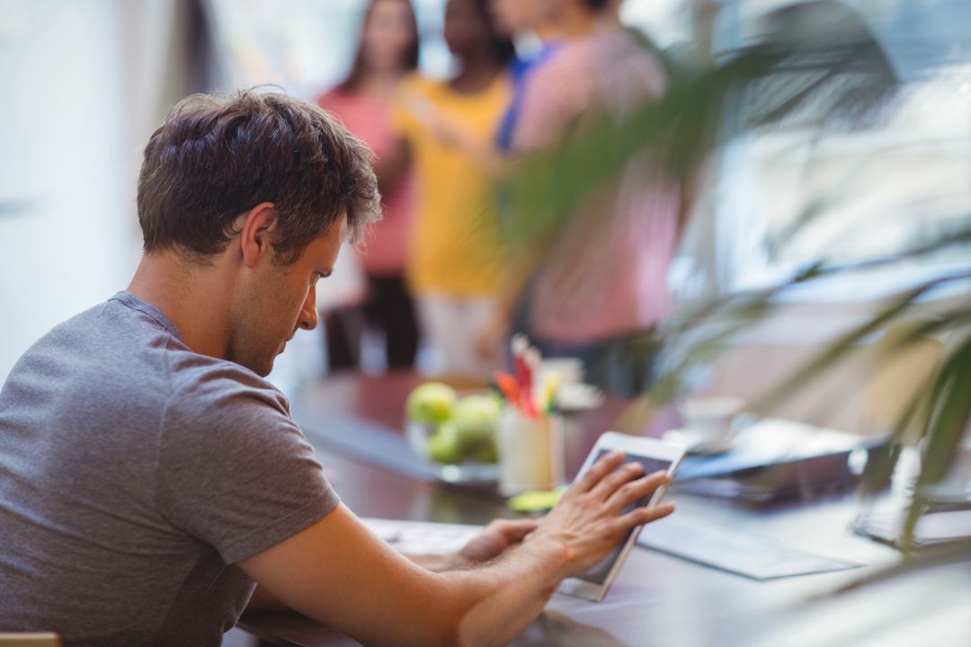 Focused Executive Using Tablet in Office Workspace