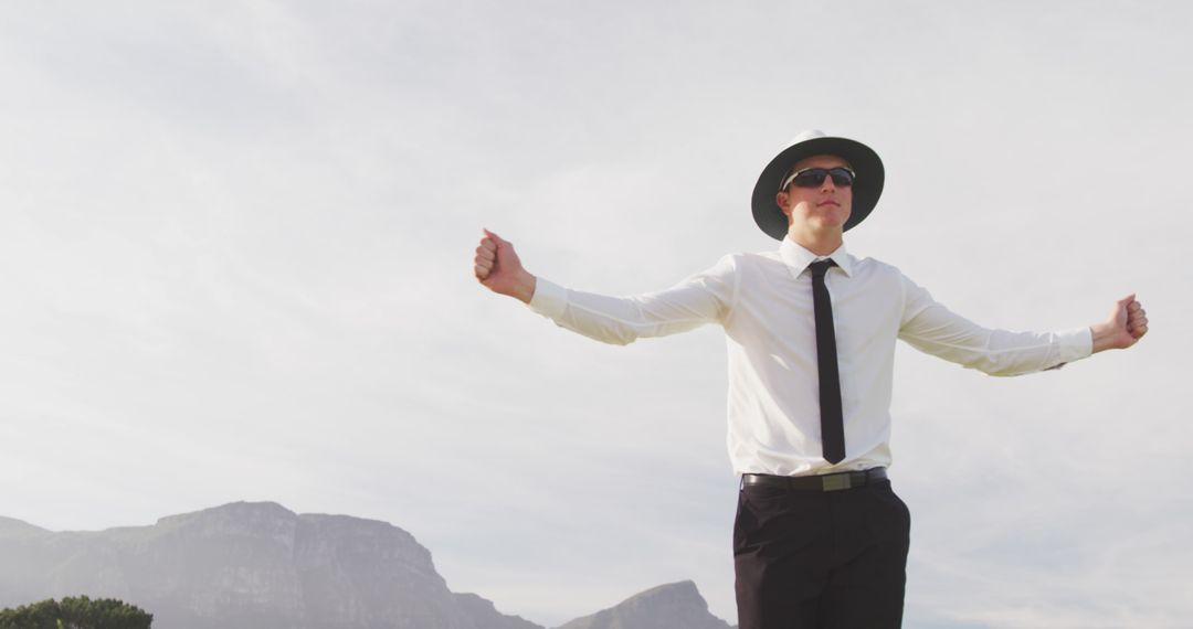 Cricket Umpire Making Signals on Field with Mountain Background