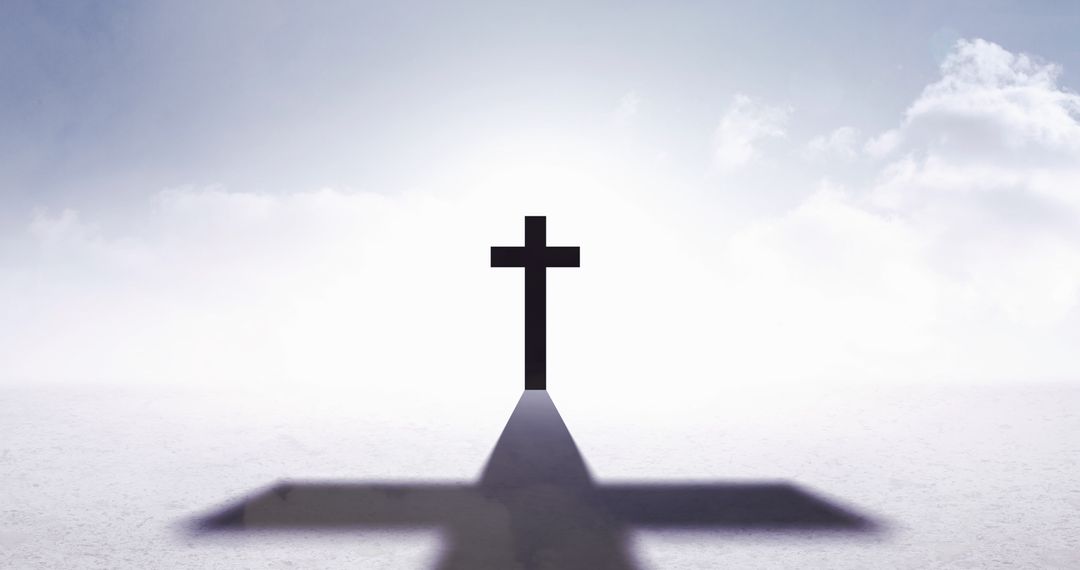 Silhouette of Cross with Long Shadow on Cloudy Horizon