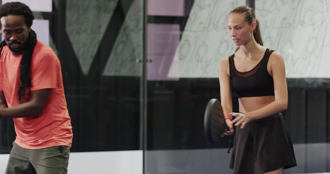 Diverse Athletes Practicing Padel Tennis Indoors for Agility and Teamwork