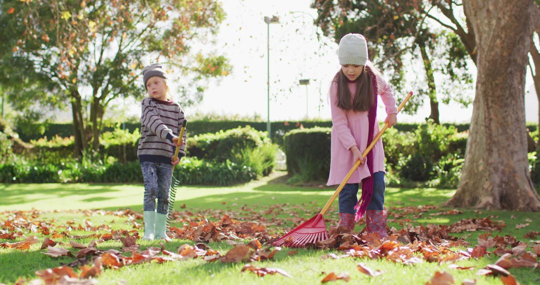 Children Raking Autumn Leaves in Park During Fall Season - Free Images, Stock Photos and Pictures on Pikwizard.com