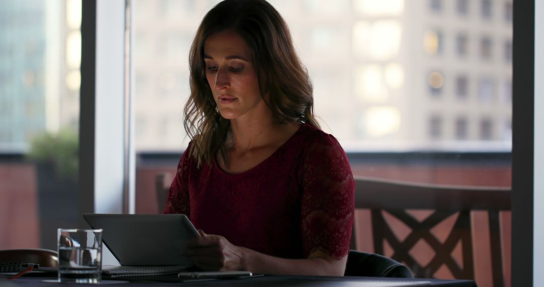 Confident businesswoman using tablet in modern hotel conference room