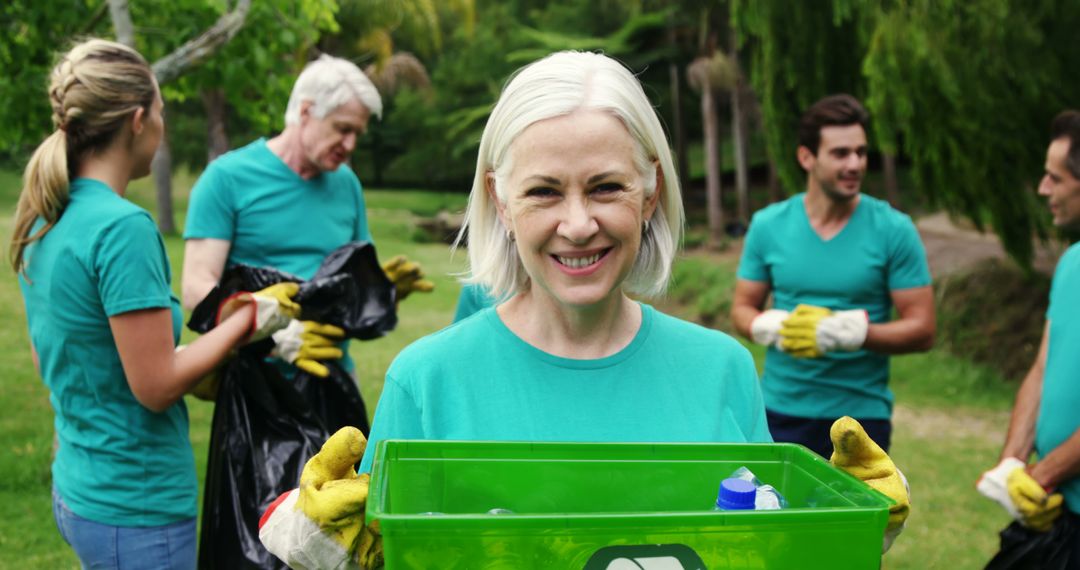 Smiling Volunteers Collecting Recyclable Materials Outdoors - Free Images, Stock Photos and Pictures on Pikwizard.com