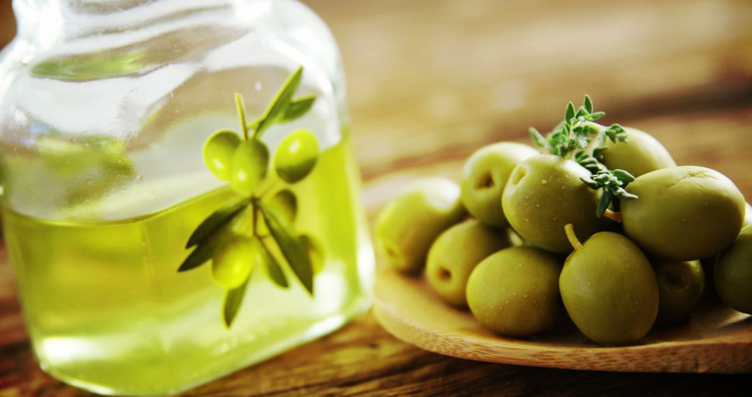 Fresh Green Olives and Olive Oil with Rustic Wooden Spoon - Free Images, Stock Photos and Pictures on Pikwizard.com