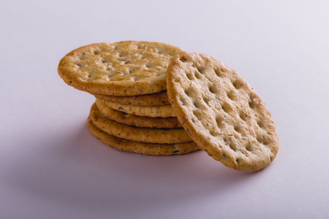 Close-up of stacked crackers over white background with copy space - Free Images, Stock Photos and Pictures on Pikwizard.com