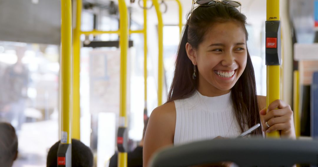 Smiling Woman Riding Public Bus Holding Onto Handrail - Free Images, Stock Photos and Pictures on Pikwizard.com