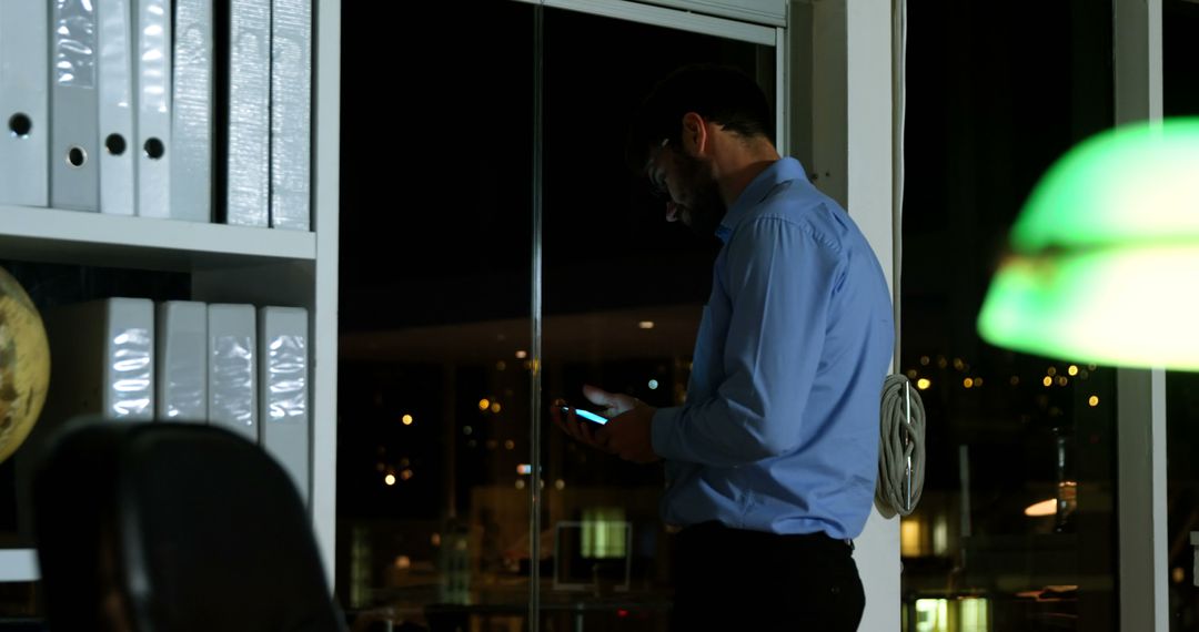 Businessman Working Late Night on Smartphone in Office - Free Images, Stock Photos and Pictures on Pikwizard.com