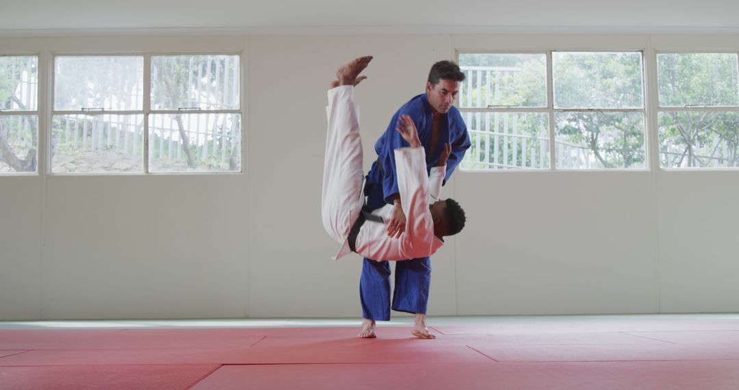 Male Judoka Performing Advanced Throw in Training Dojo - Free Images, Stock Photos and Pictures on Pikwizard.com