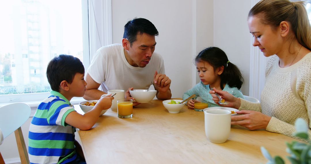 Family Having Healthy Breakfast Together at Dining Table - Free Images, Stock Photos and Pictures on Pikwizard.com