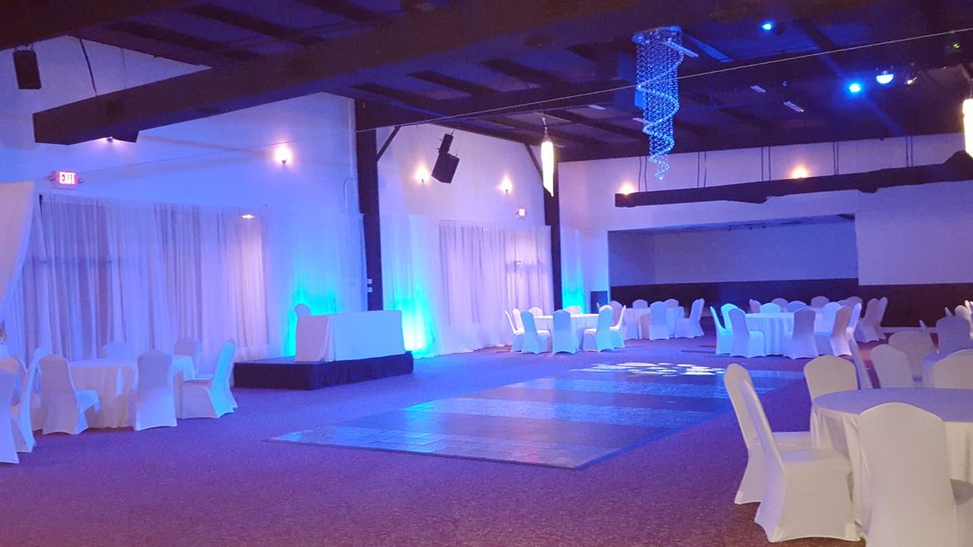 Empty Event Venue With Blue Lighting and White Covered Chairs - Free Images, Stock Photos and Pictures on Pikwizard.com