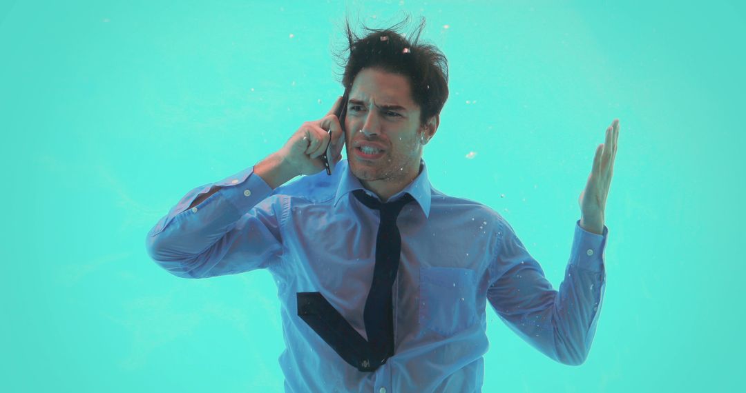 Frustrated Businessman Dressed in Suit Underwater Using Smartphone - Free Images, Stock Photos and Pictures on Pikwizard.com