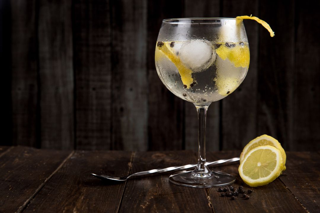 Refreshing Gin and Tonic with Lemon Garnish on Rustic Table