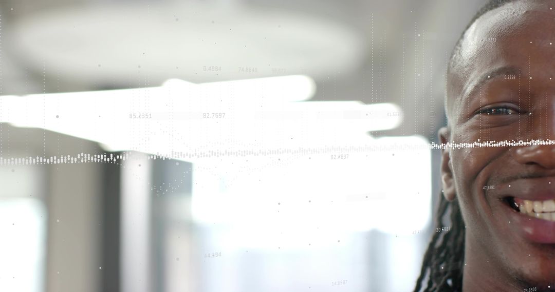 Smiling professional with dreadlocks in modern office featuring waveform data overlay