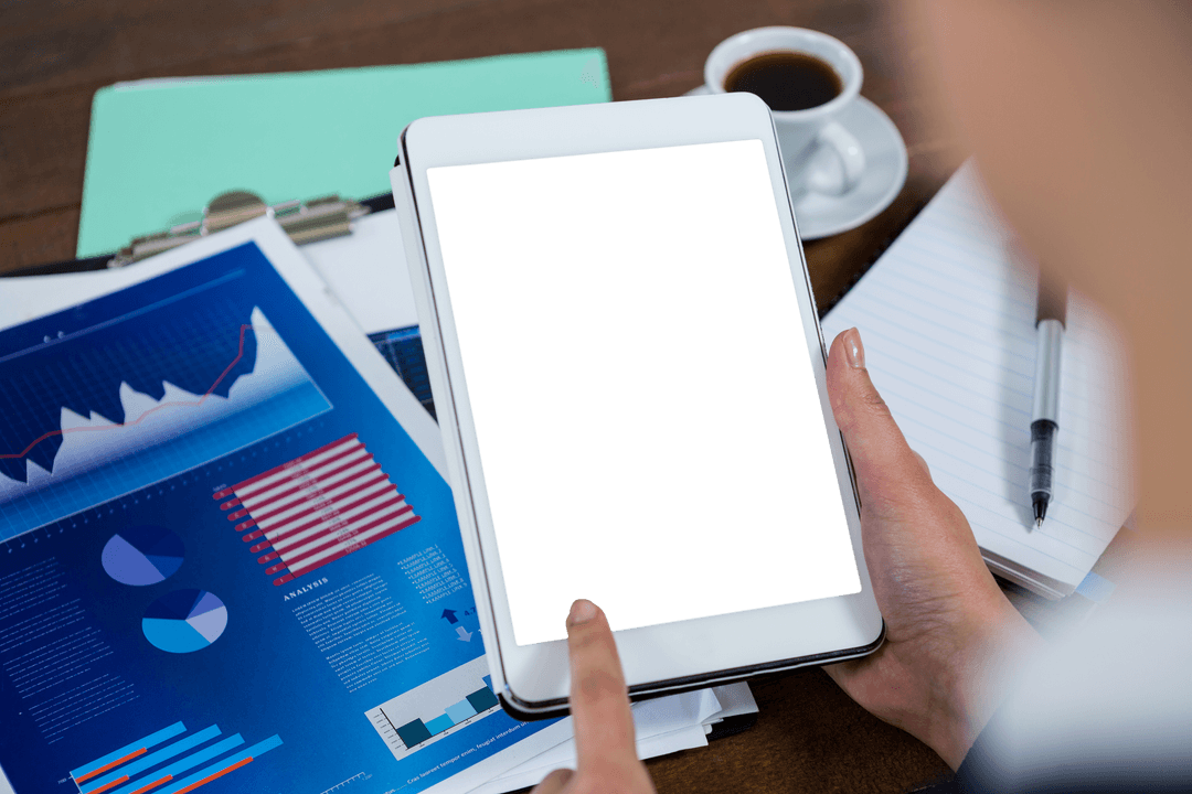 Transparent Screen Tablet with Business Charts and Coffee at Office Desk