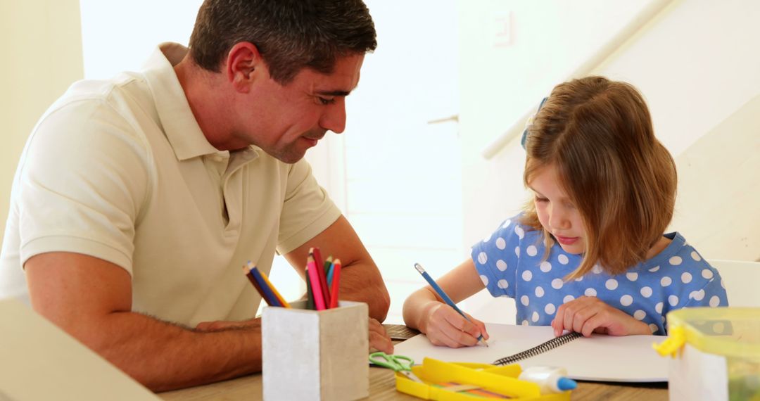 Father and Young Daughter Drawing Together on Living Room Floor - Free Images, Stock Photos and Pictures on Pikwizard.com