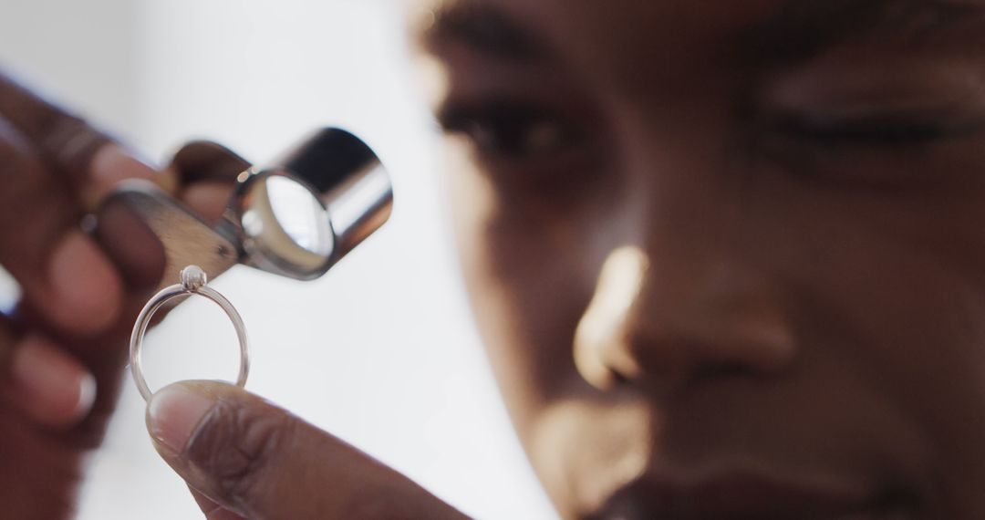 Closeup of jeweler inspecting diamond ring with loupe - Free Images, Stock Photos and Pictures on Pikwizard.com