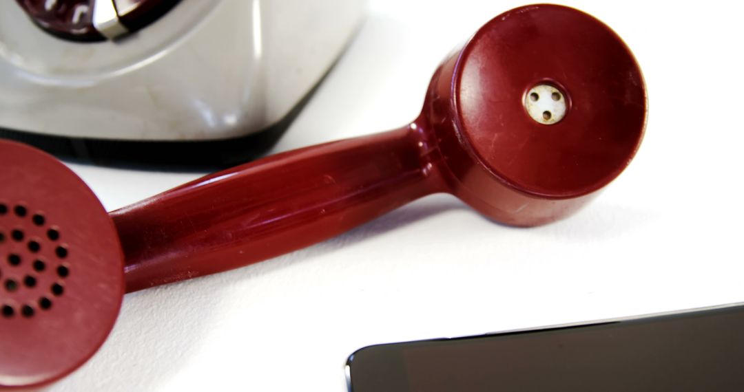 Vintage Red Rotary Phone Handset and Modern Smartphone on White Background - Free Images, Stock Photos and Pictures on Pikwizard.com