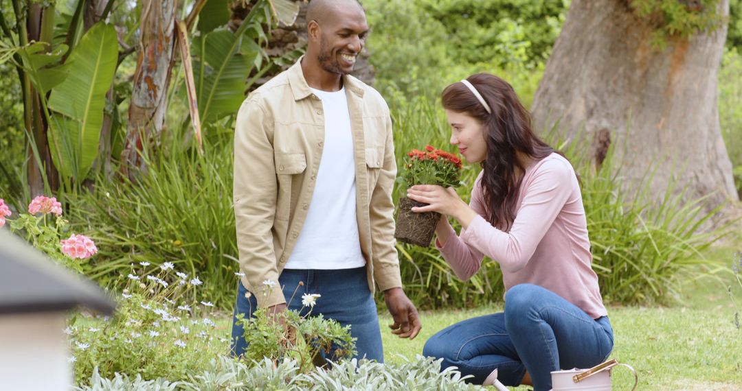 Diverse Couple Enjoying Gardening in Scenic Backyard