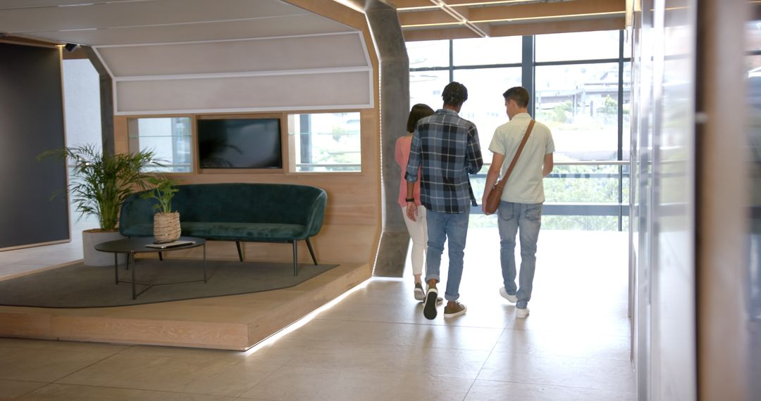 Colleagues Walking in Modern Office Hallway for Team Collaboration