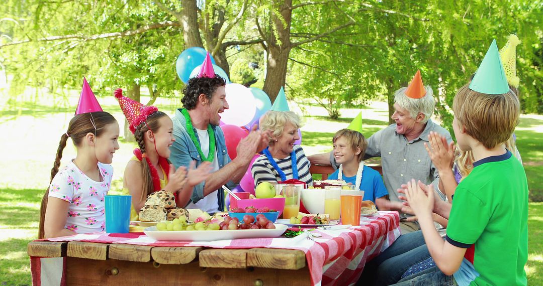 Multi-generational family celebrating birthday outdoors - Free Images, Stock Photos and Pictures on Pikwizard.com