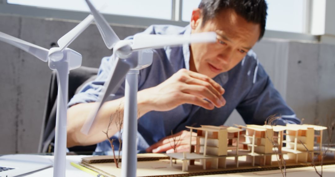 Architect Analyzing Sustainable Building Model in Modern Office