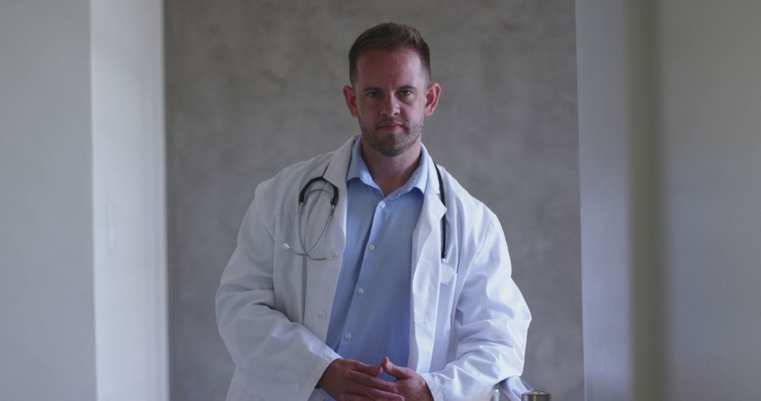 Confident Male Doctor in White Coat with Stethoscope in Modern Clinic - Free Images, Stock Photos and Pictures on Pikwizard.com