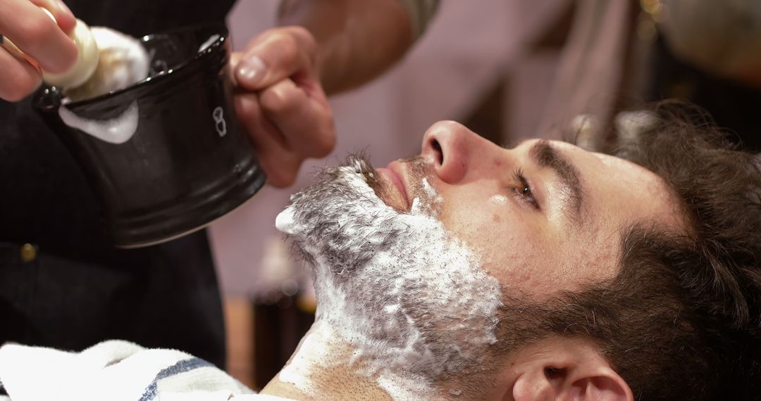 Man Getting Shaving Foam Applied by Barber at Barbershop - Free Images, Stock Photos and Pictures on Pikwizard.com