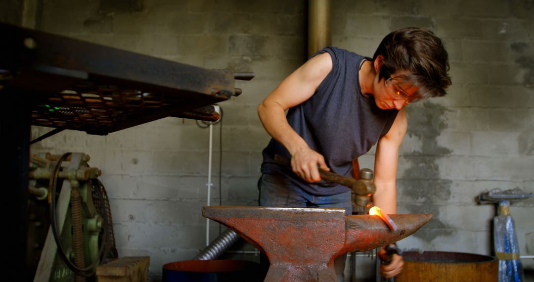 Female Blacksmith Forging Metal in Rustic Workshop - Free Images, Stock Photos and Pictures on Pikwizard.com