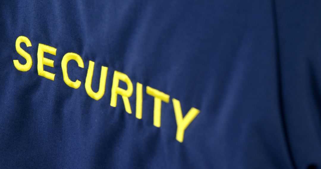 Close-Up of Security Officer Uniform with Yellow Text - Free Images, Stock Photos and Pictures on Pikwizard.com