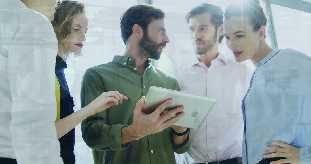 Multiracial Team Analyzing Data with Tablet in Modern Office