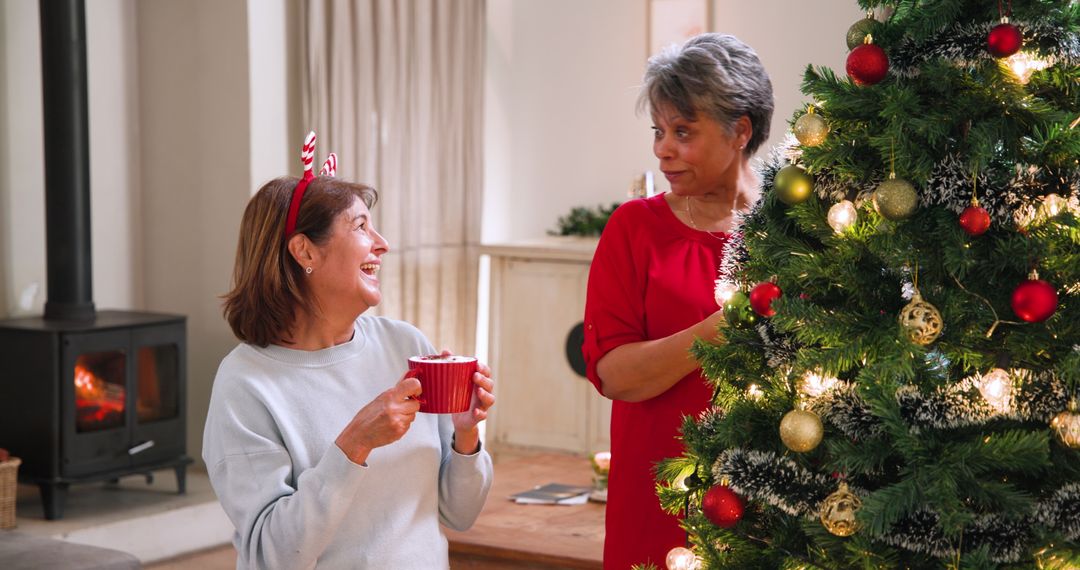 Mother and Daughter Celebrating Christmas Decorating Tree
