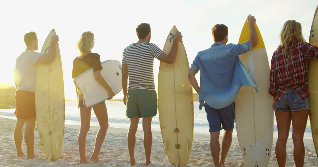 Group of Friends with Surfboards Watching the Sunset on Beach - Free Images, Stock Photos and Pictures on Pikwizard.com